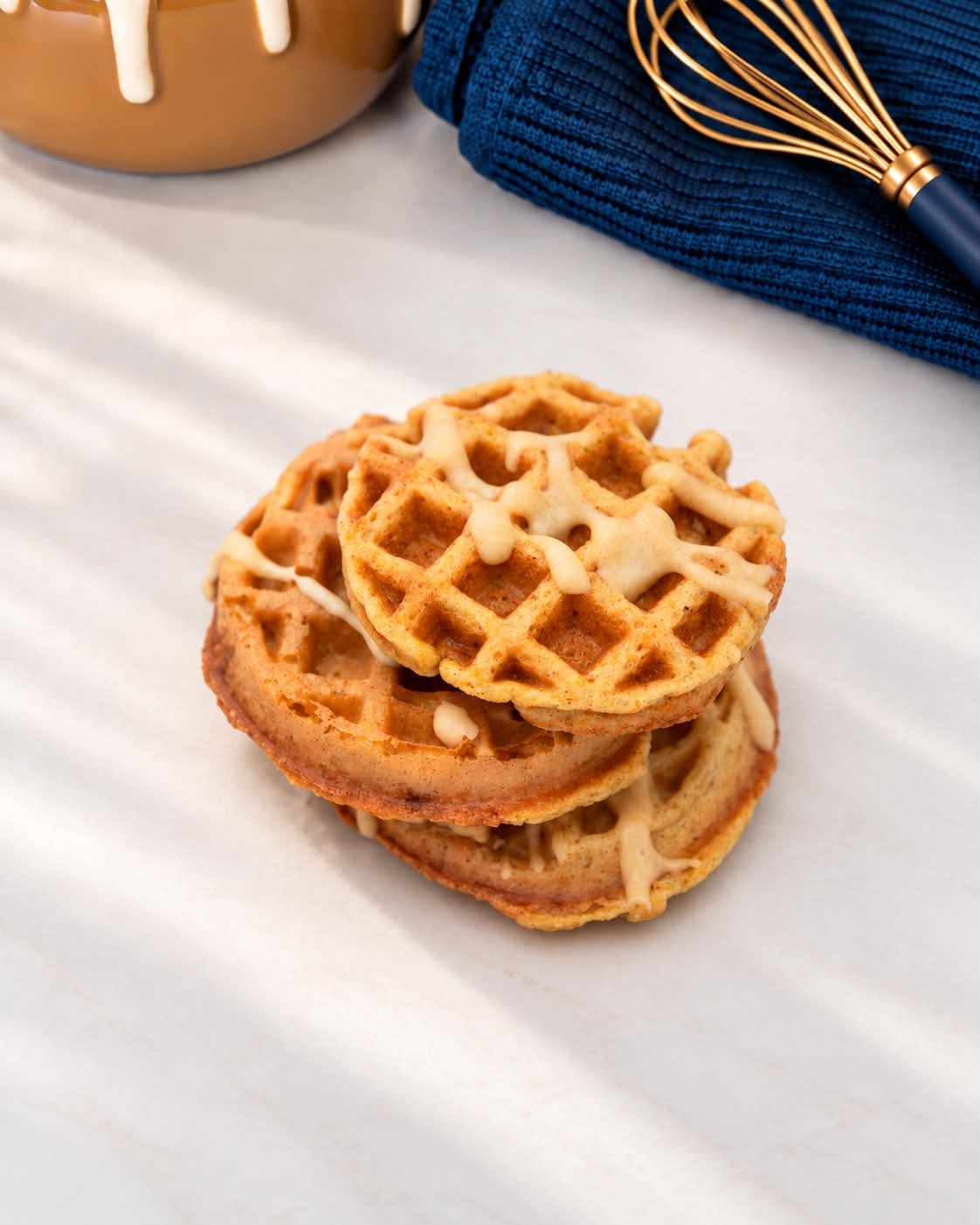 A stack of WORTH waffle dog treats with drizzle
